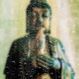 Manjushri Statue Seen Through Raindrops on a Window
