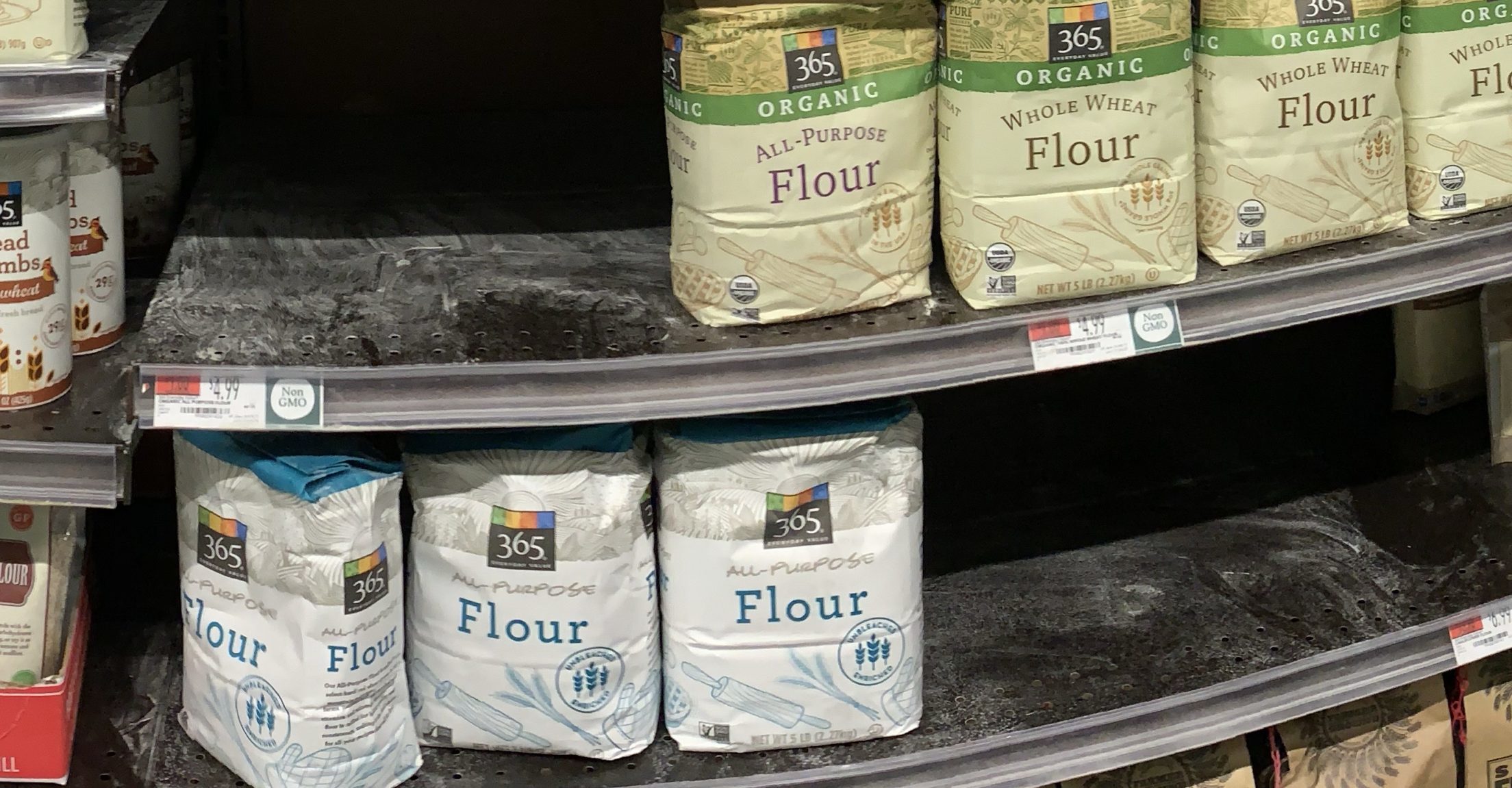 half empty shelf of bags of flour